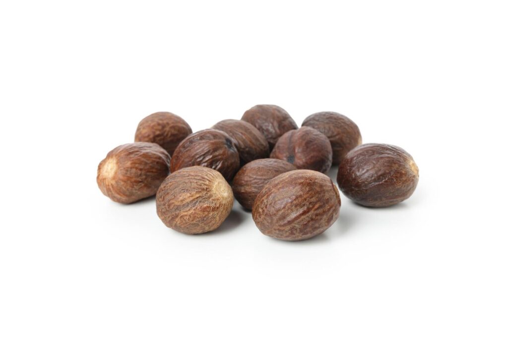 Whole dried nutmeg kernels close view